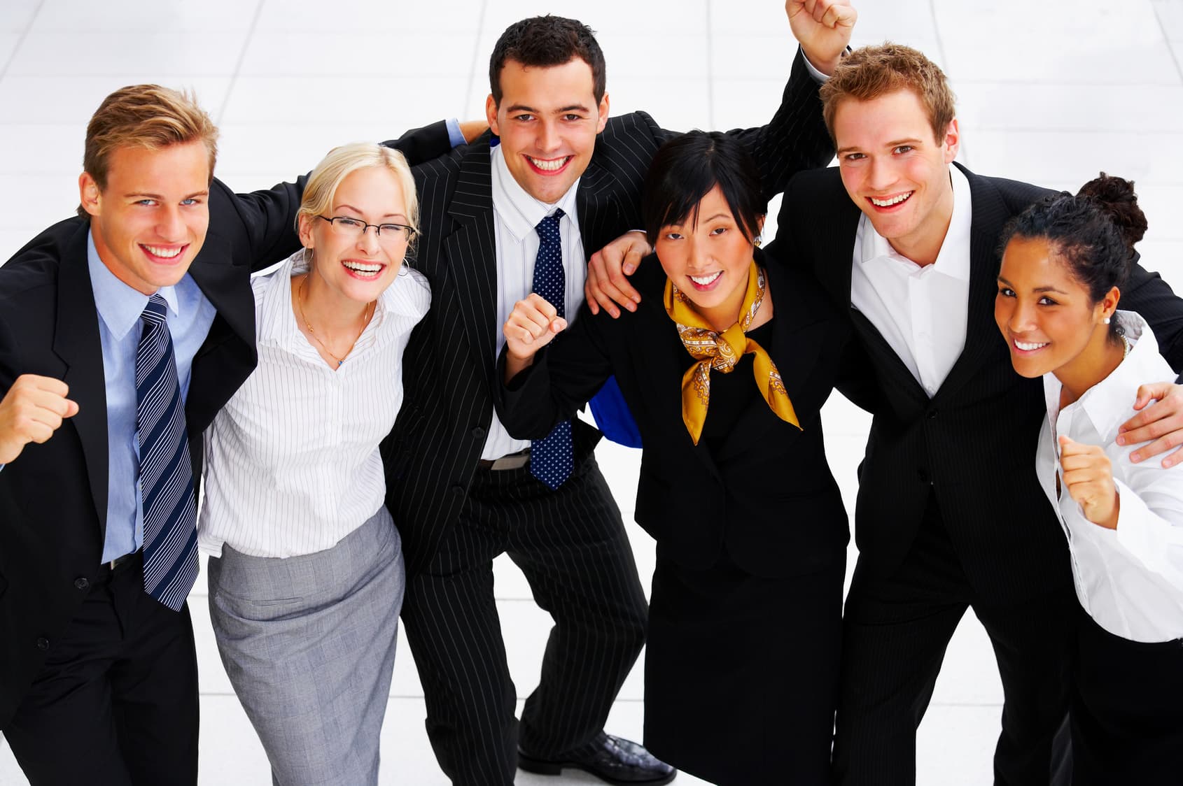 A smiling group of young professionals celebrating together